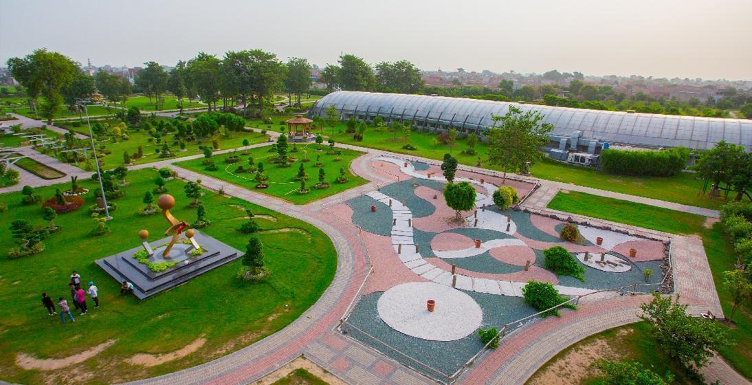 Wide green lawns and trees inside Jallo Park, Lahore